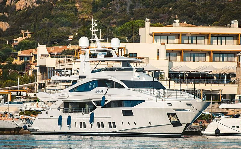 a large white yacht in a harbor aboard RANIA Yacht for Sale