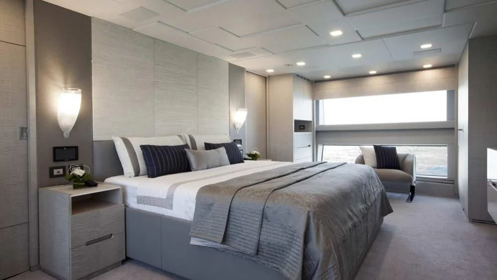 a large bedroom with a bed and a chair aboard RANIA Yacht for Sale