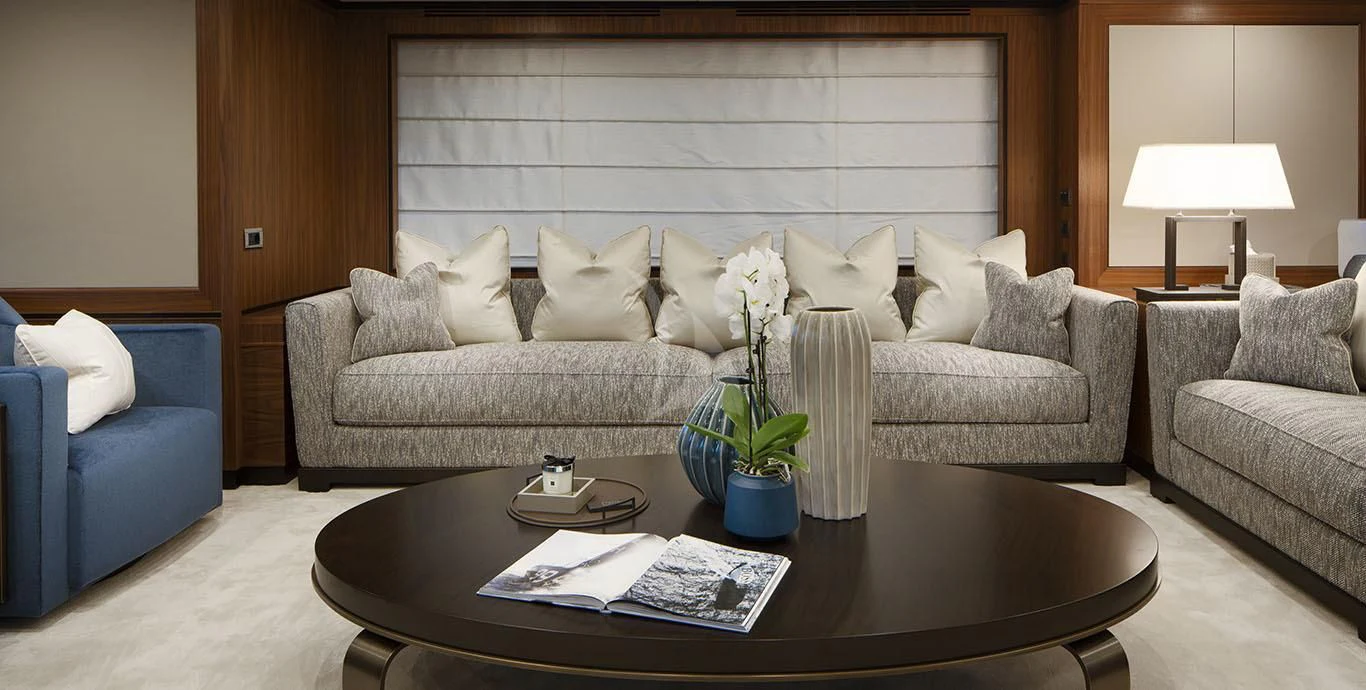 a living room with a couch and a coffee table aboard RANIA Yacht for Sale
