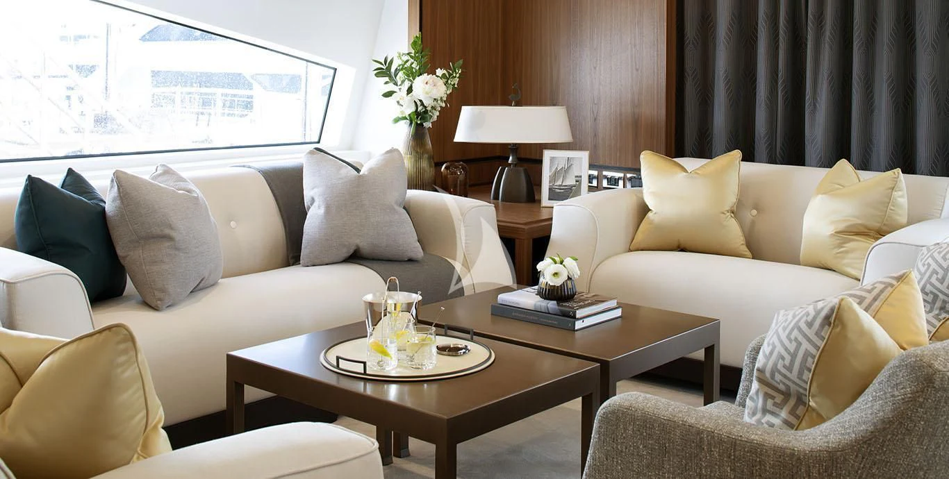 a living room with a couch and coffee table aboard RANIA Yacht for Sale