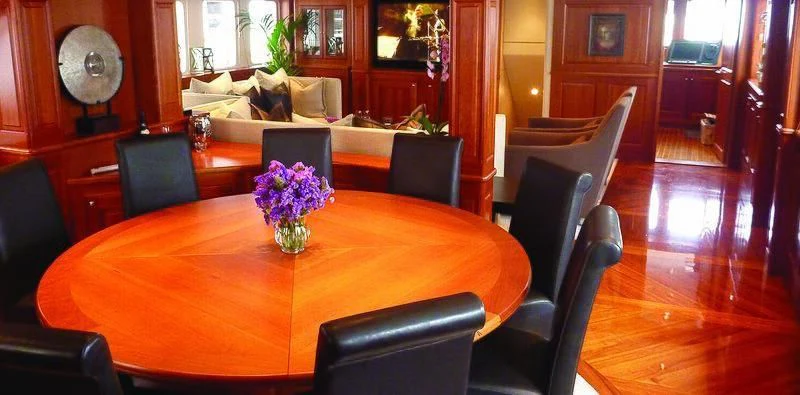 a dining table in a room aboard SUNNY HILL Yacht for Sale