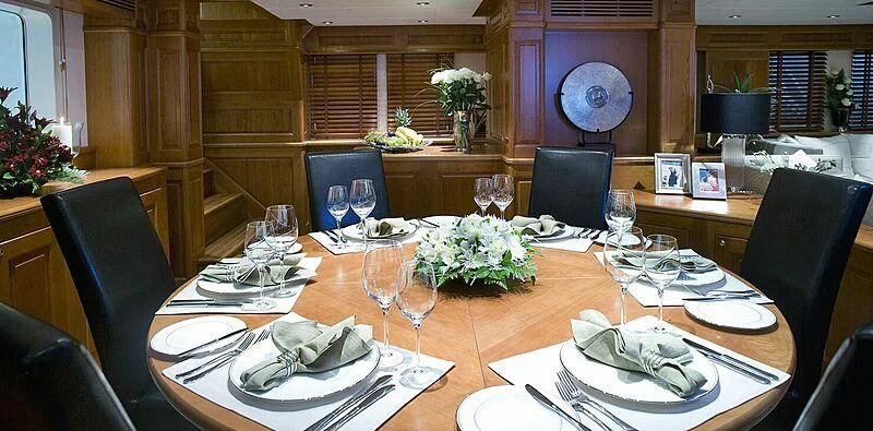 a table set with place settings aboard SUNNY HILL Yacht for Sale