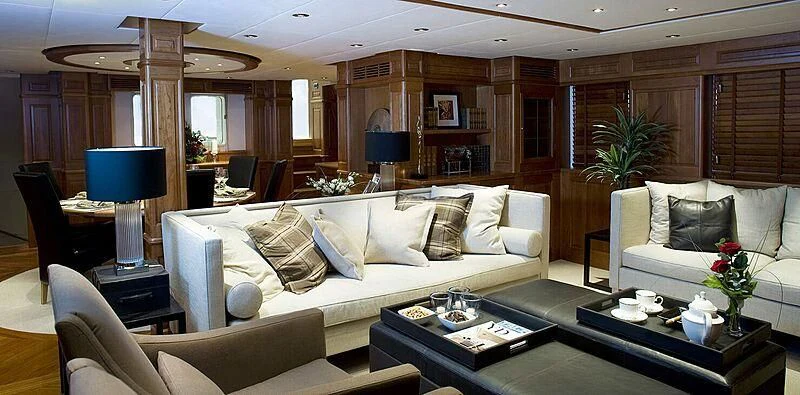 a living room with a white couch and a table with a lamp on it aboard SUNNY HILL Yacht for Sale