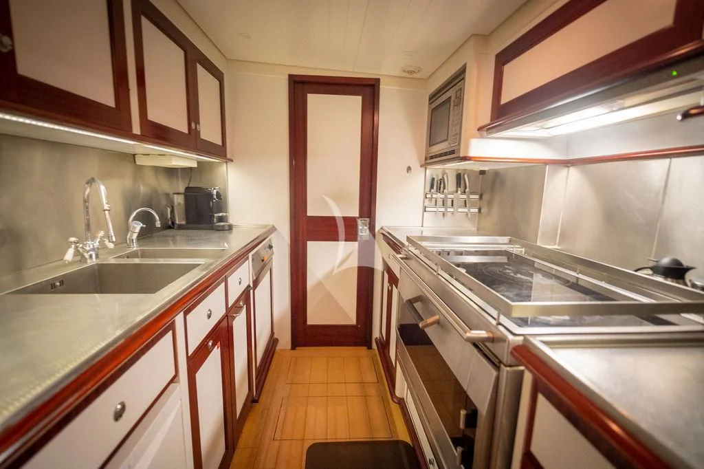 a kitchen with a stove and sink aboard AURELIUS Yacht for Sale