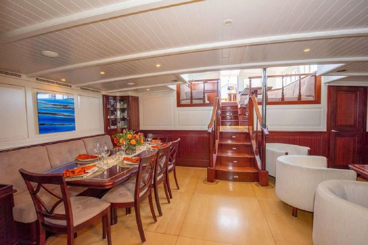 a dining room with a staircase aboard AURELIUS Yacht for Sale