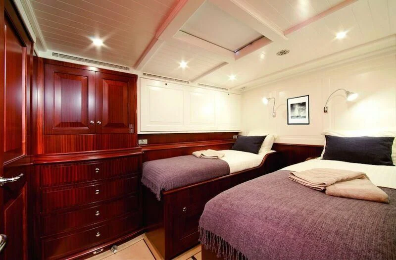 a room with a couple of beds aboard AURELIUS Yacht for Sale