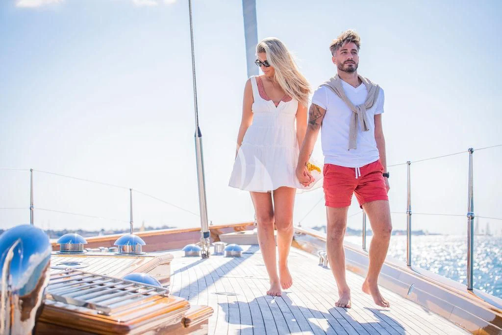 a man and woman walking on a rooftop aboard AURELIUS Yacht for Sale