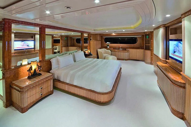 a bedroom with a bed and a tv aboard BARENTS Yacht for Charter