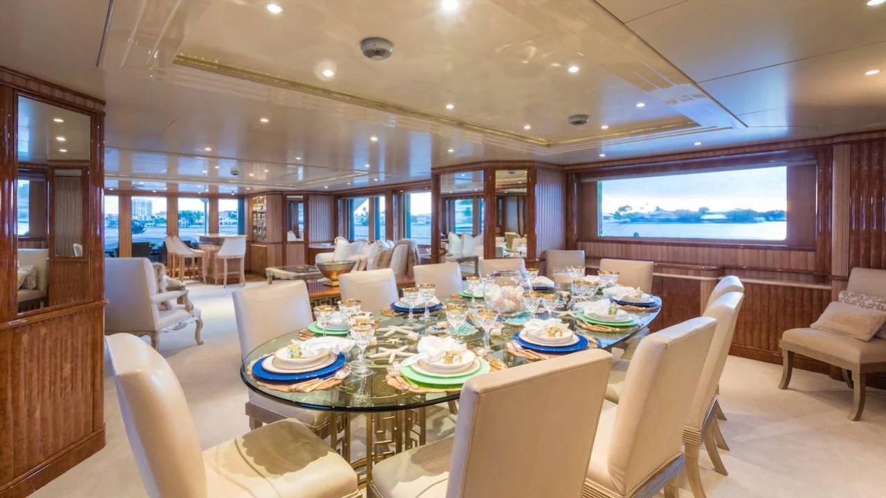a large room with a table and chairs aboard BARENTS Yacht for Charter