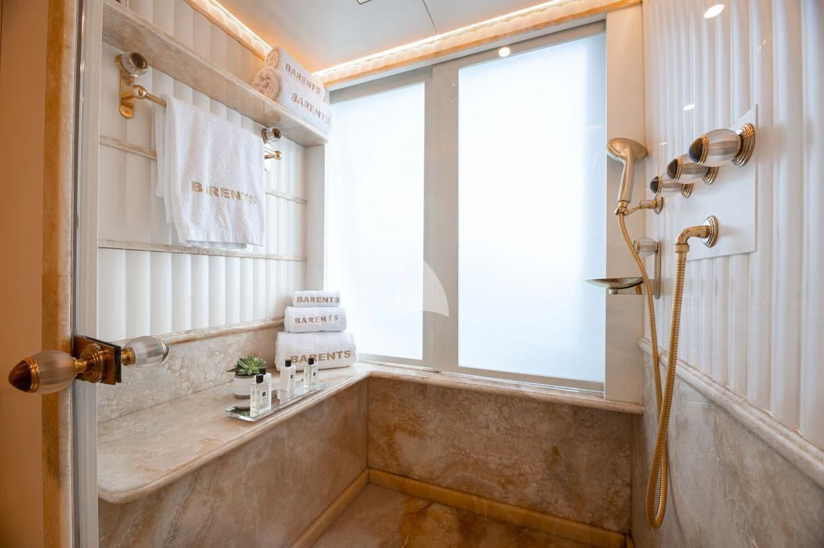 a bathroom with a countertop sink and a mirror aboard BARENTS Yacht for Charter