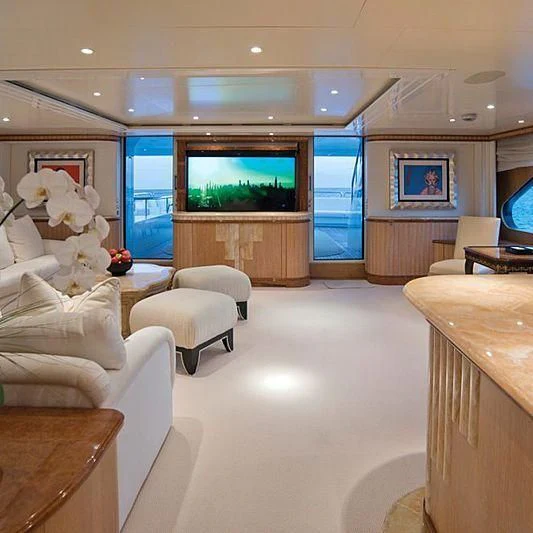 a room with a tv and couches aboard BARENTS Yacht for Charter