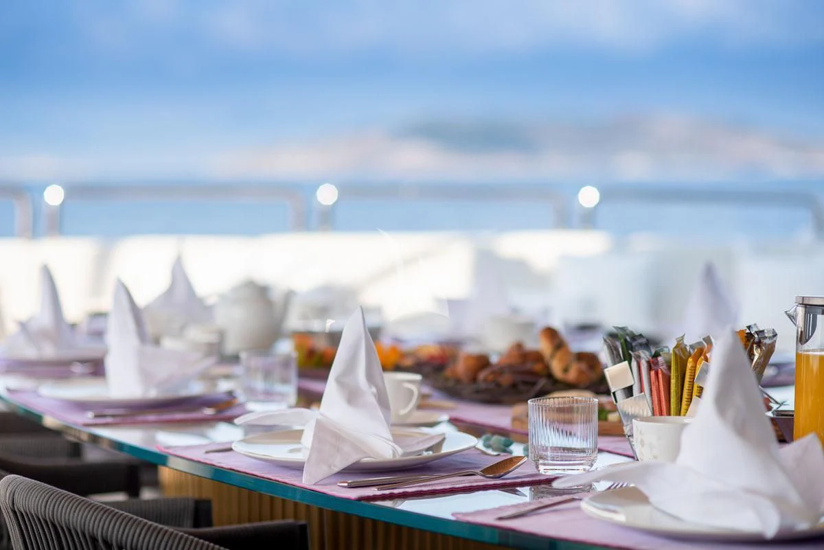 a table with food and drinks on it aboard BARENTS Yacht for Charter