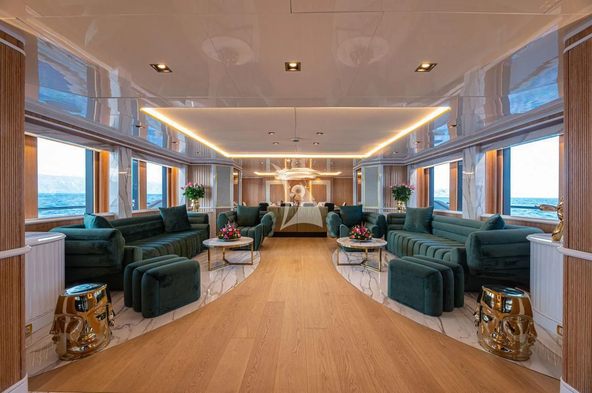 a living room with green furniture aboard BARENTS Yacht for Charter