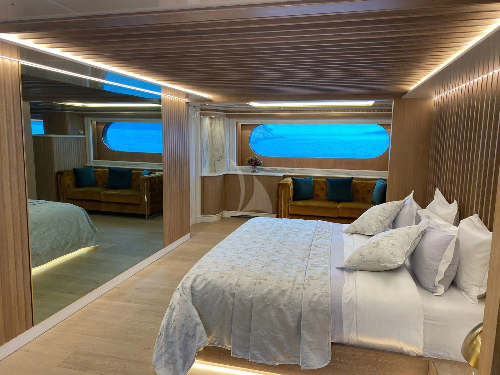 a room with a bed and a large window aboard BARENTS Yacht for Charter