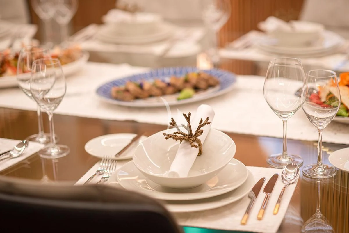 a table with plates of food and glasses on it aboard BARENTS Yacht for Charter