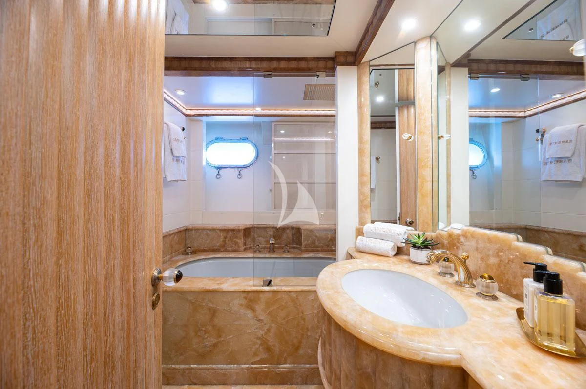 a bathroom with a tub sink and a sink aboard BARENTS Yacht for Charter