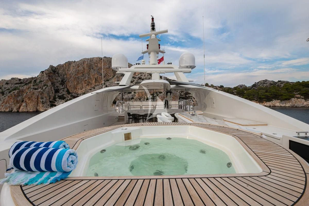 a pool with a blue towel on it and a white ship in the background aboard BARENTS Yacht for Charter