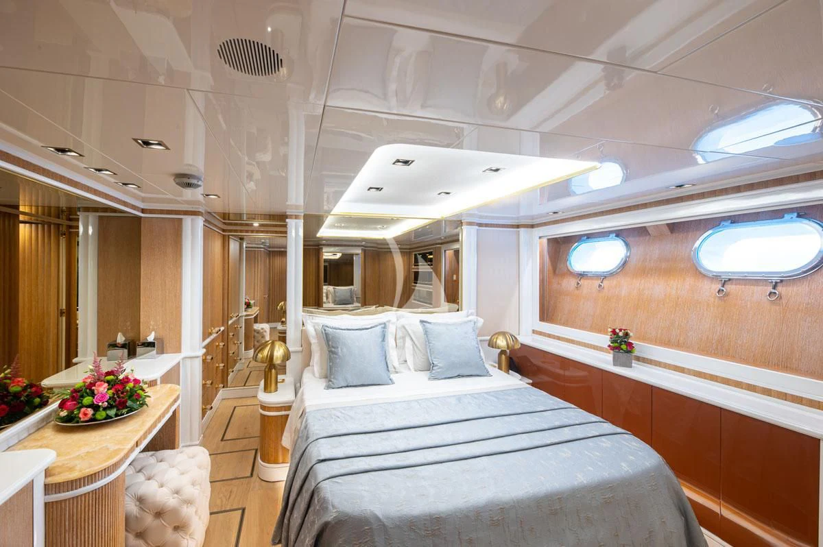 a room with a bed and a table aboard BARENTS Yacht for Charter