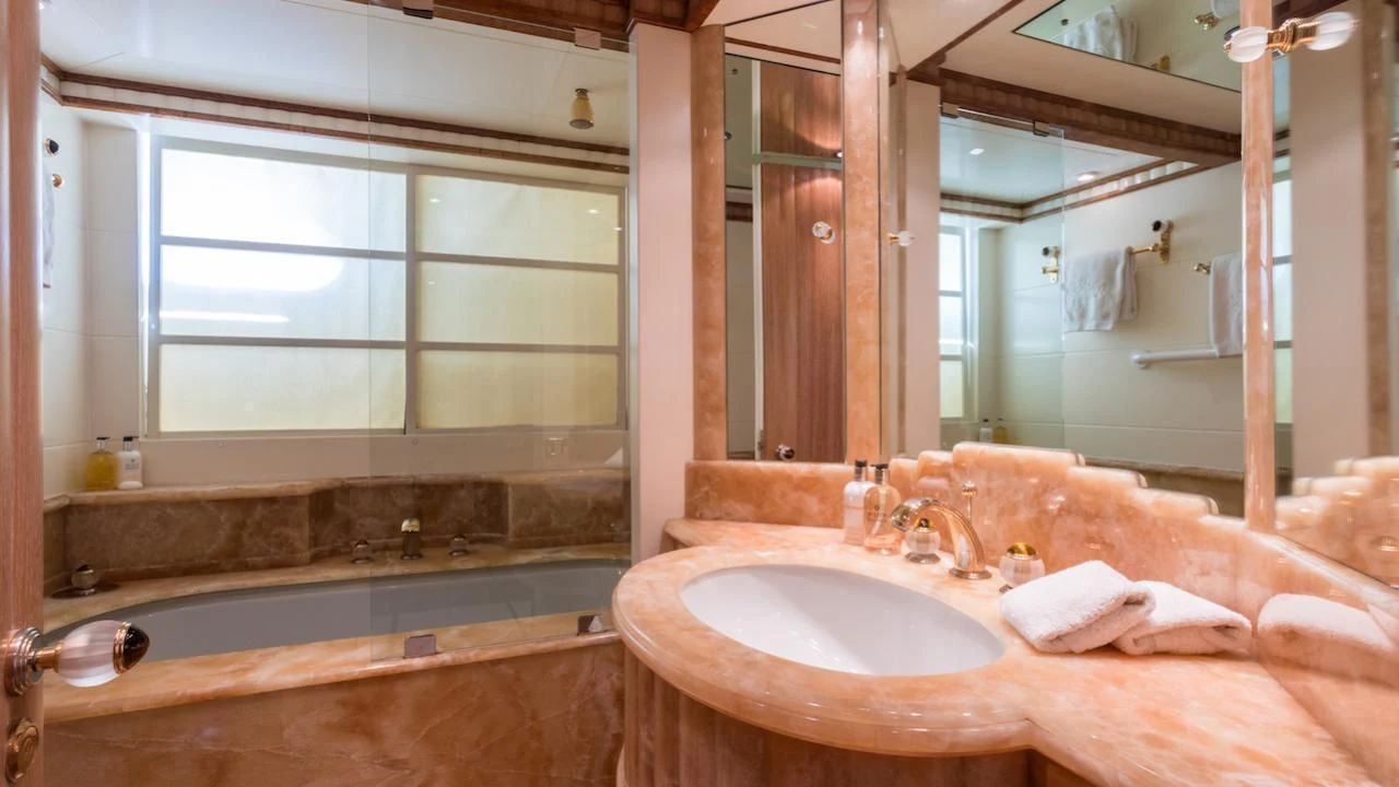 a bathroom with a tub sink and a sink aboard BARENTS Yacht for Charter