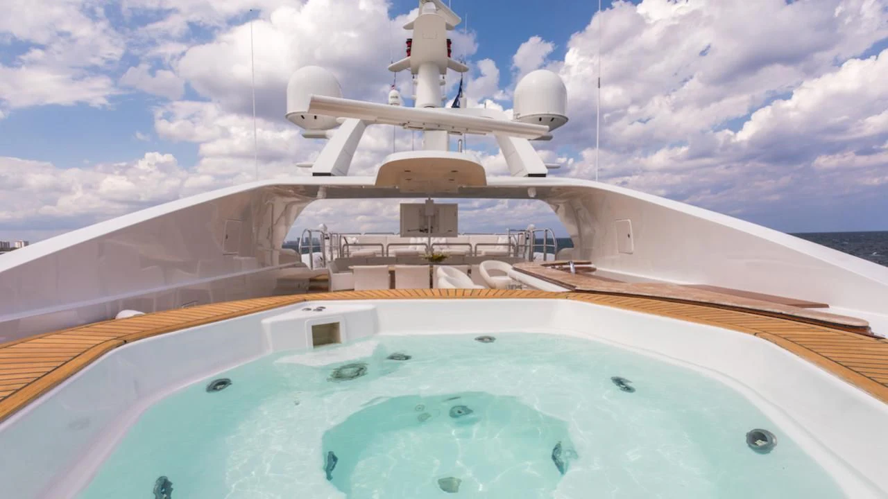 a large white boat on a body of water aboard BARENTS Yacht for Charter