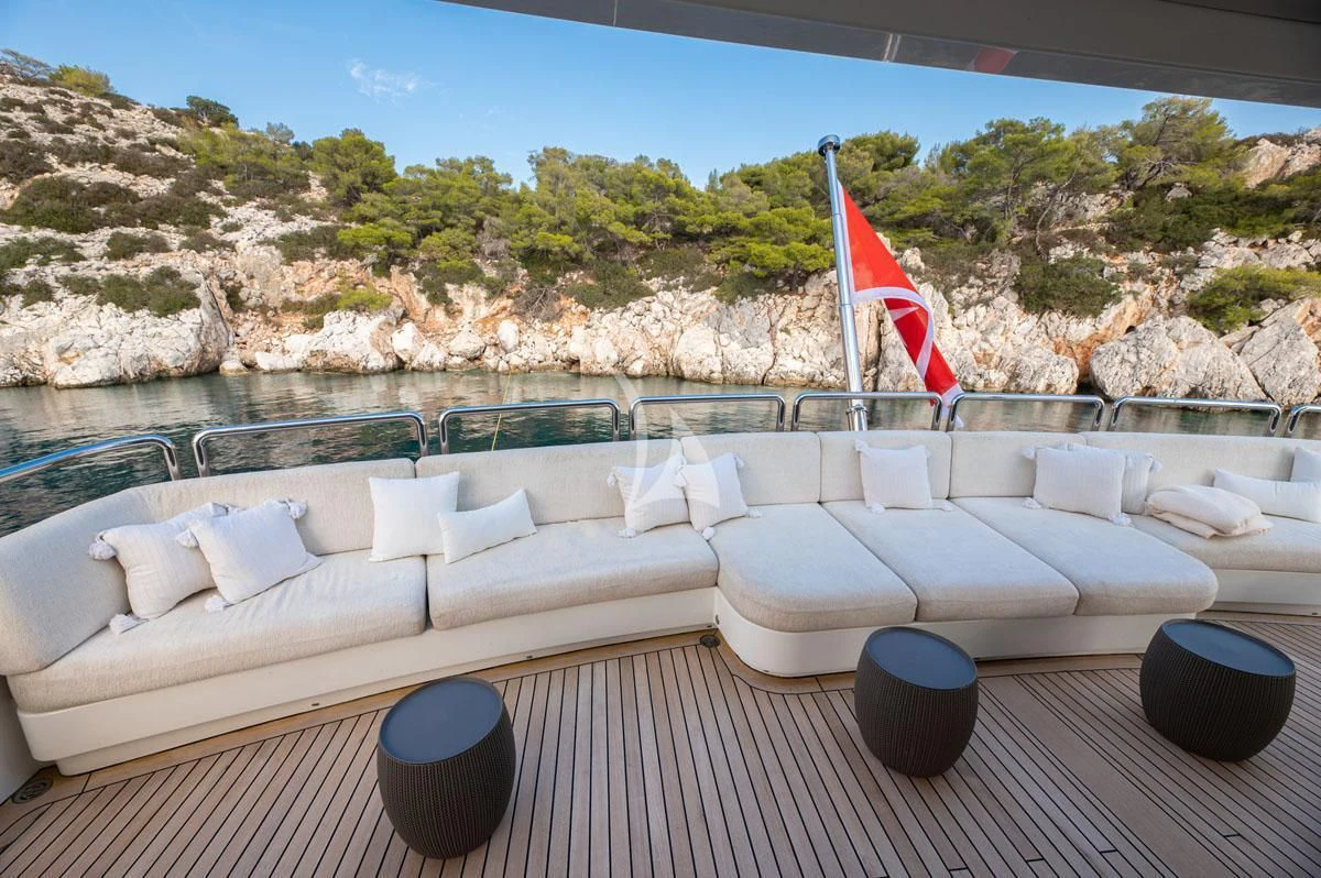 a deck with a large pool and a beach and trees aboard BARENTS Yacht for Charter