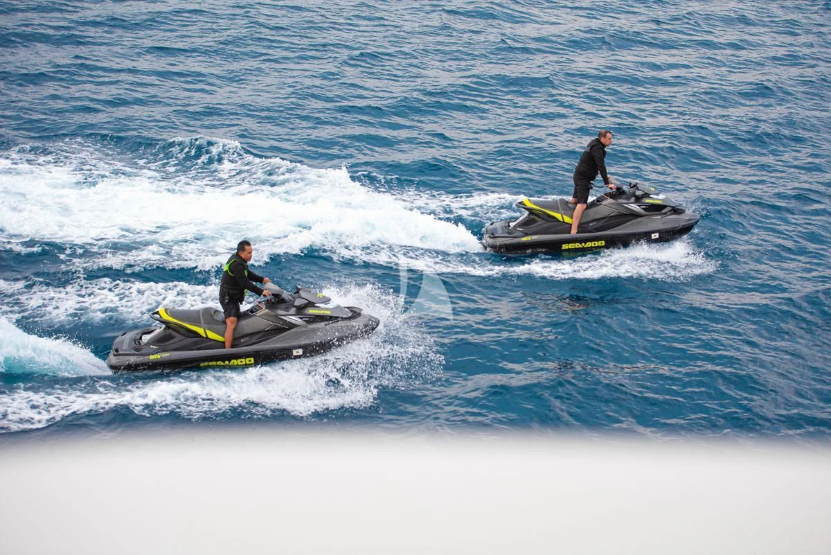 a couple of men on surfboards in the ocean aboard BARENTS Yacht for Charter