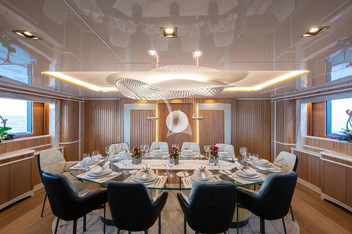 a large dining room with a large table and chairs aboard BARENTS Yacht for Charter