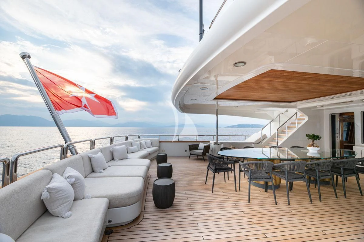 a large lounge area with a large deck and a large umbrella aboard BARENTS Yacht for Charter