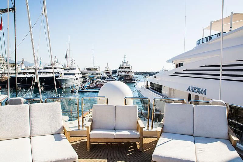 a deck with chairs and boats aboard BARENTS Yacht for Charter