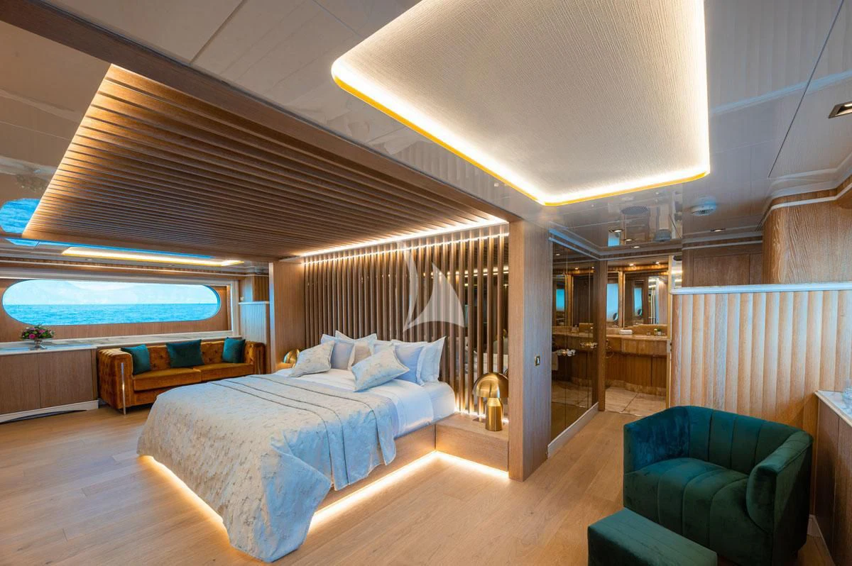 a room with a bed and a couch aboard BARENTS Yacht for Charter