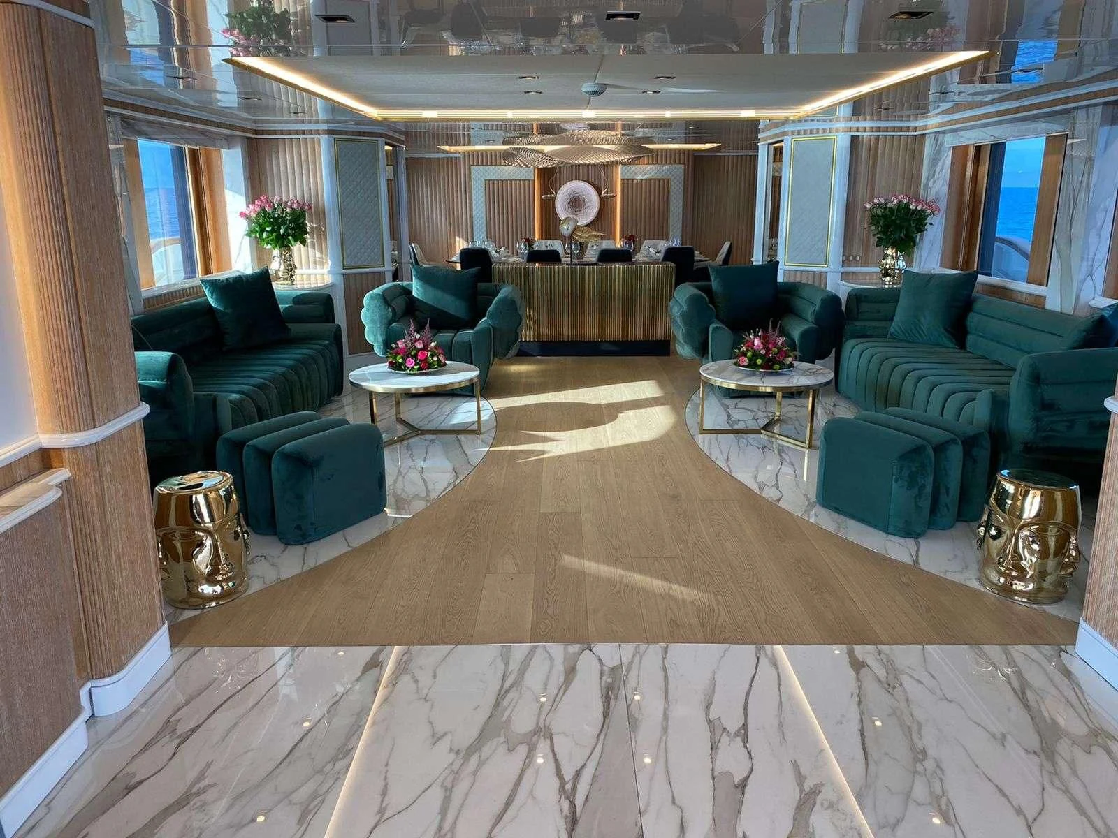 a living room with green furniture aboard BARENTS Yacht for Charter