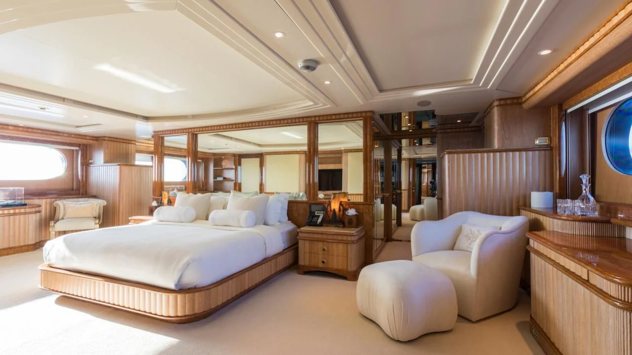 a large bedroom with a bed and a chair aboard BARENTS Yacht for Charter