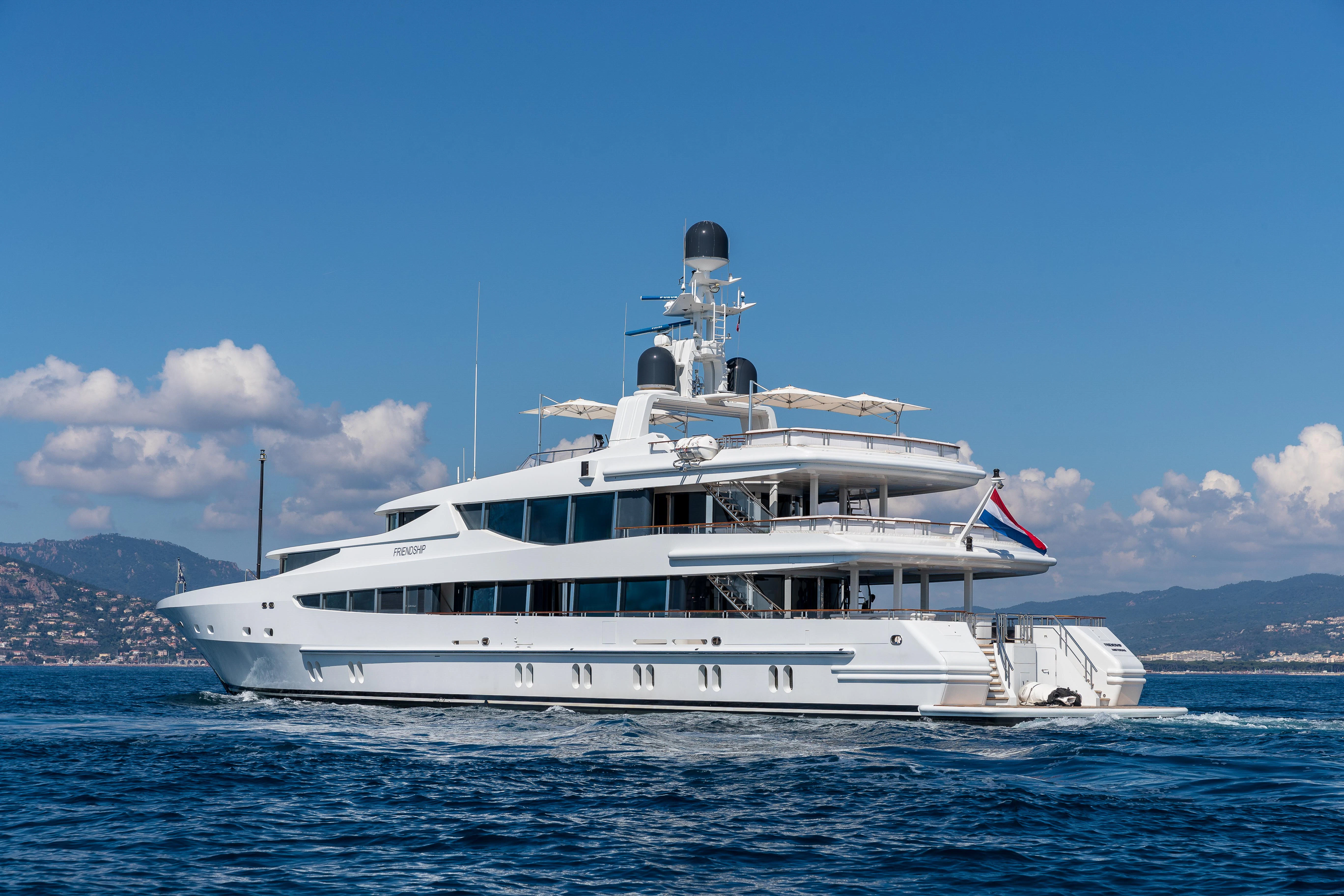 a large white boat in the water aboard FRIENDSHIP Yacht for Charter