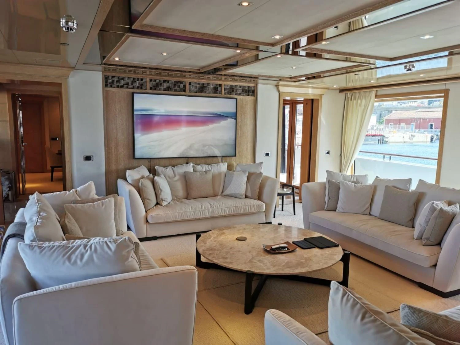 a living room with a large screen aboard FRIENDSHIP Yacht for Charter