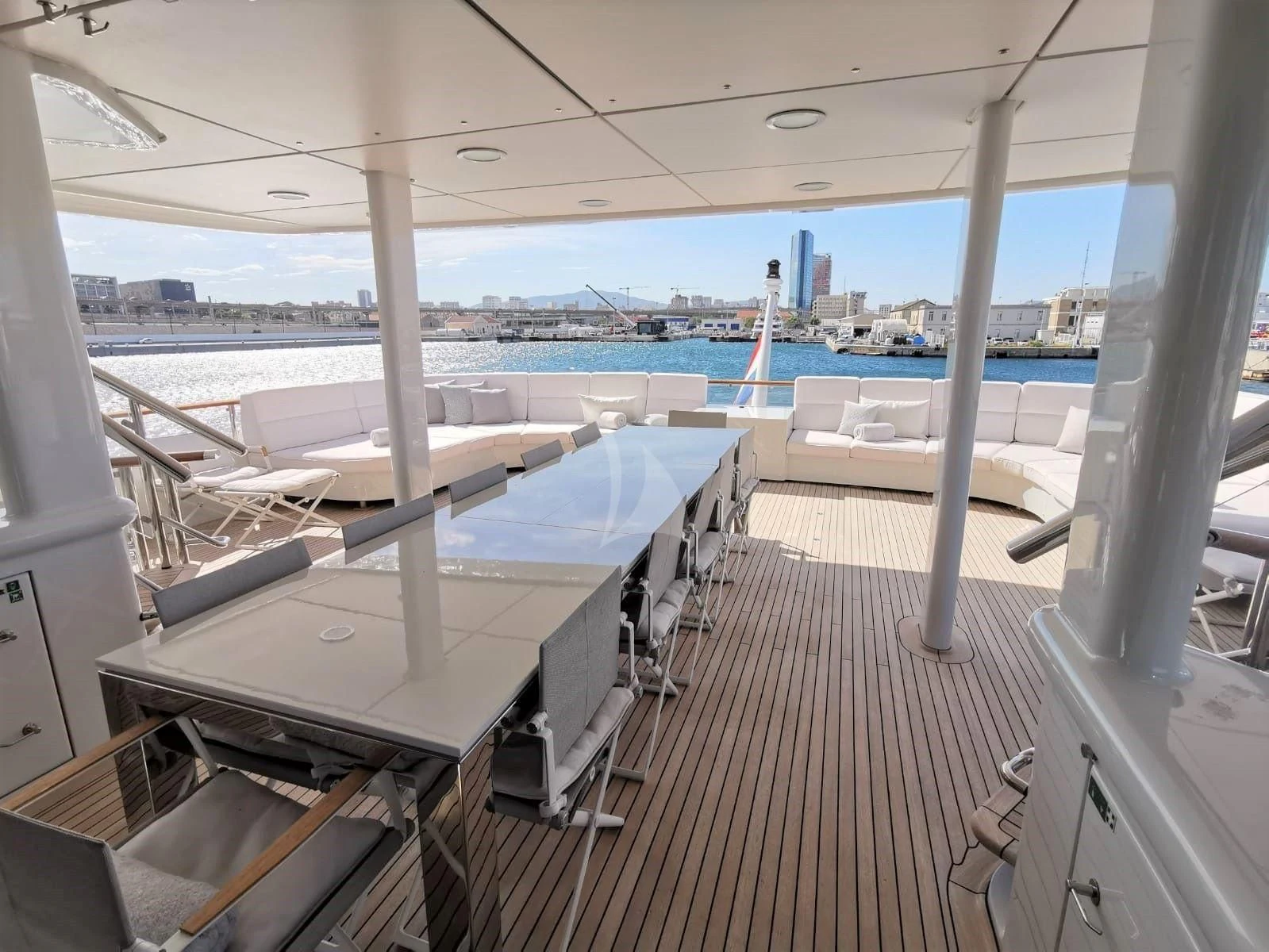 a deck with several beds aboard FRIENDSHIP Yacht for Charter