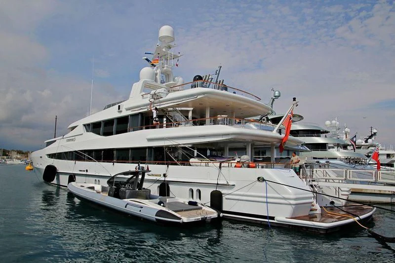 a large white boat with a red stripe on it aboard FRIENDSHIP Yacht for Charter
