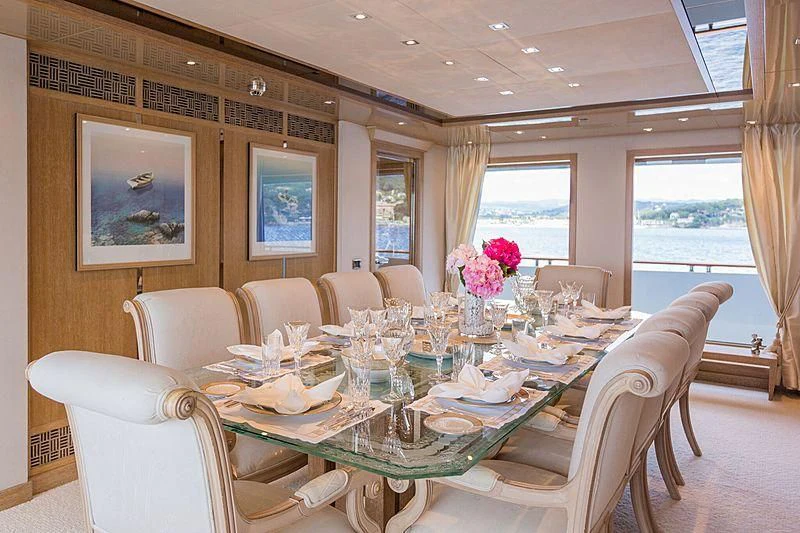 a dining room with a table set for a dinner aboard FRIENDSHIP Yacht for Charter