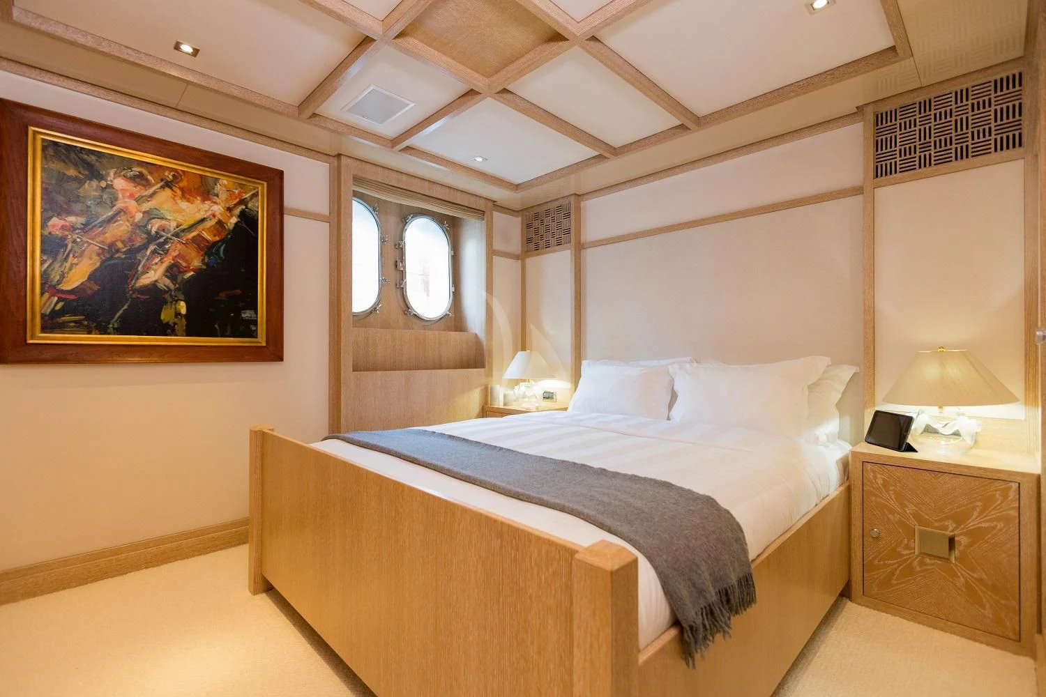 a bed with a painting on the wall aboard FRIENDSHIP Yacht for Charter