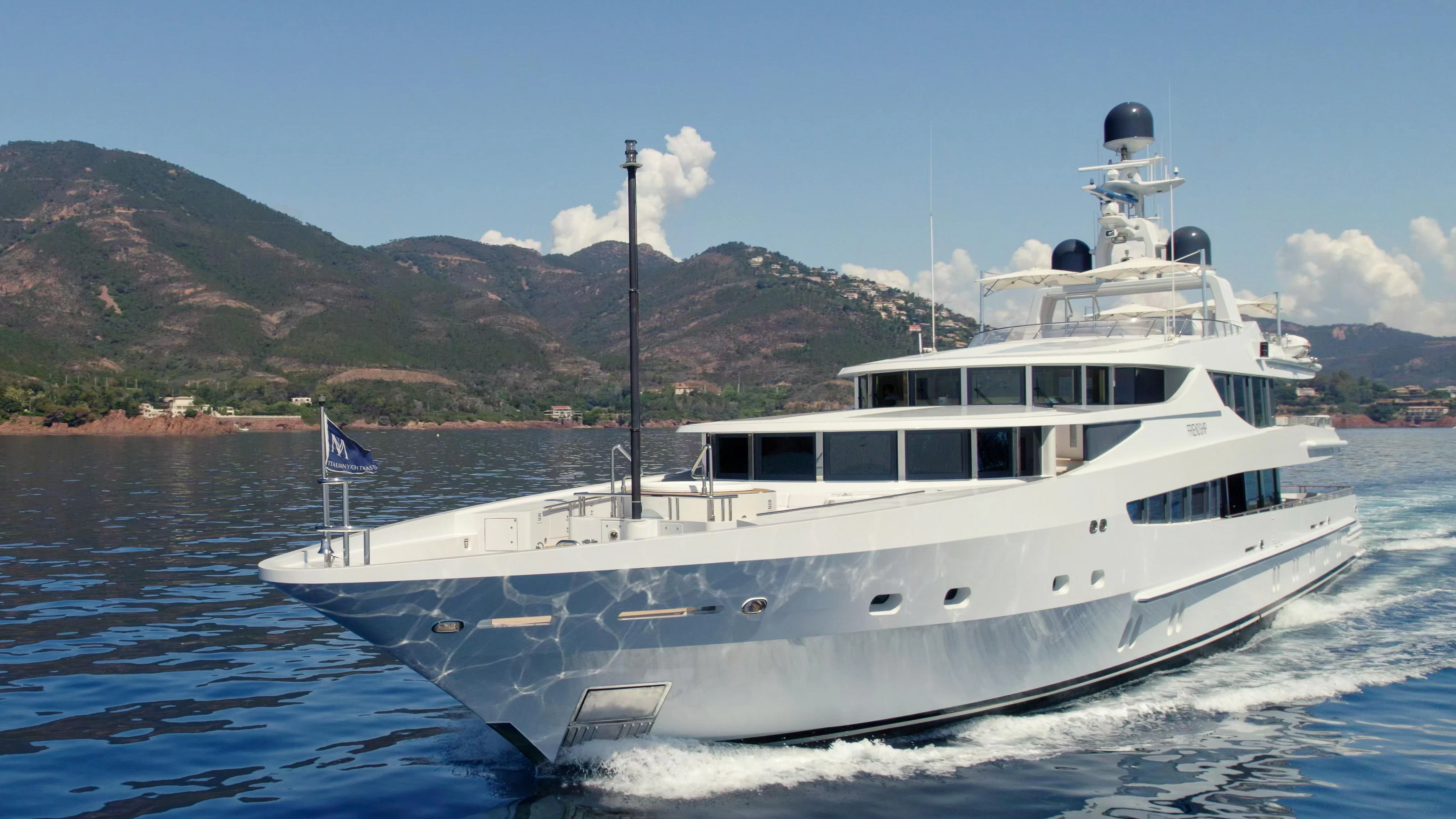 a large white boat with a flag on it aboard FRIENDSHIP Yacht for Charter
