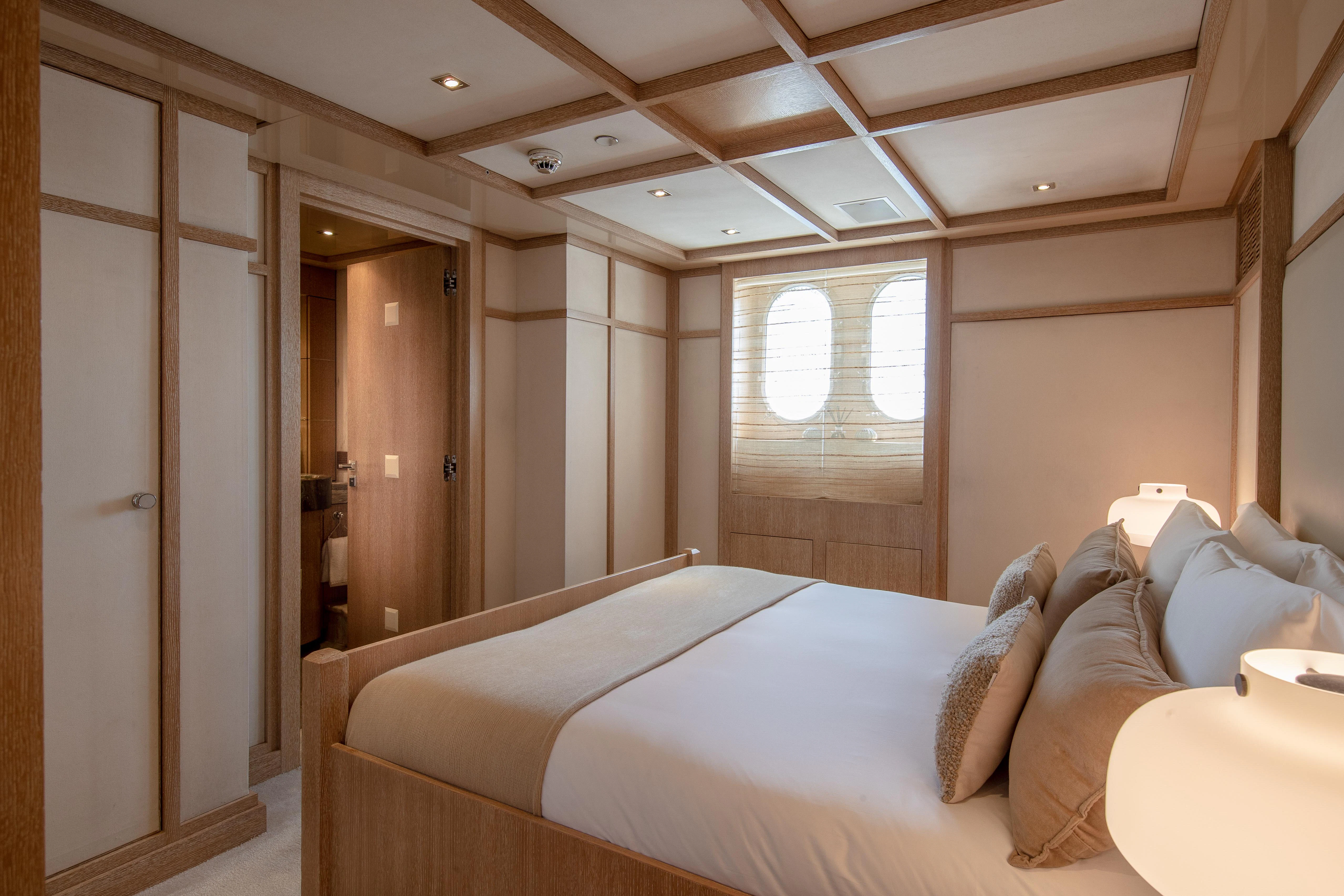 a room with a bed and a window aboard FRIENDSHIP Yacht for Charter