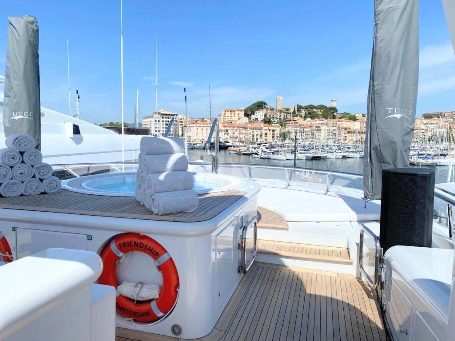 a deck with a view of a city and water aboard FRIENDSHIP Yacht for Charter