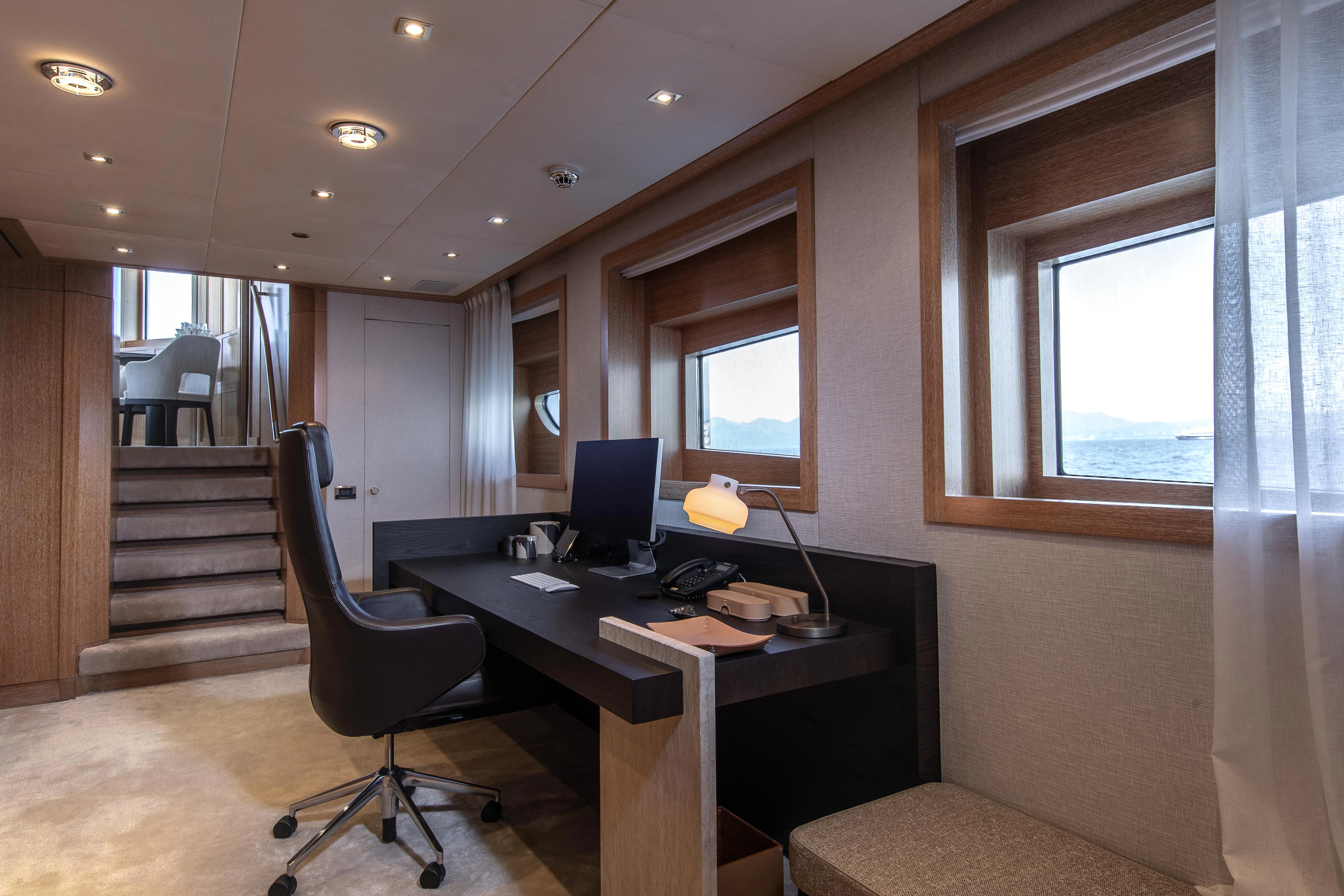 a room with a desk and a computer aboard FRIENDSHIP Yacht for Charter