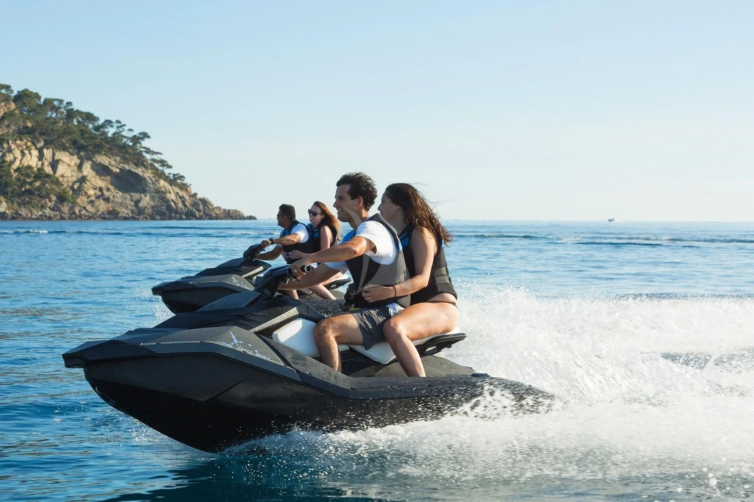 a group of people riding a jet ski in the water aboard FRIENDSHIP Yacht for Charter