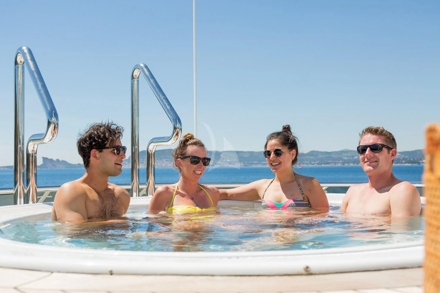 a group of people in a pool aboard FRIENDSHIP Yacht for Charter