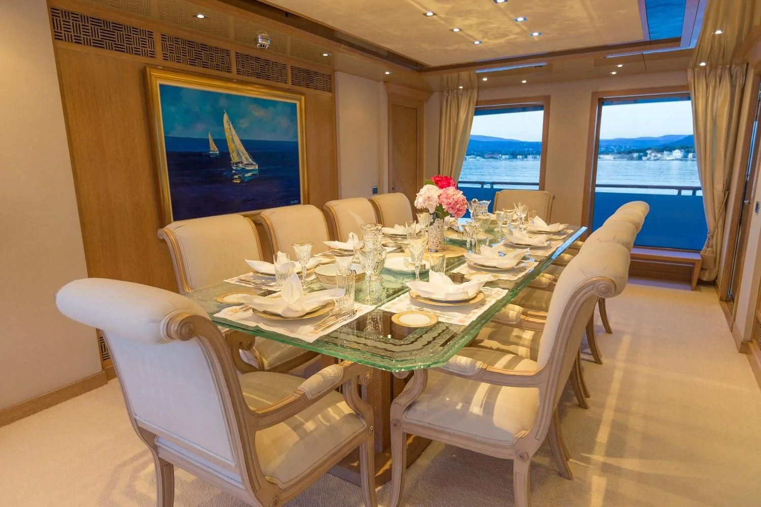 a dining room with a large screen aboard FRIENDSHIP Yacht for Charter