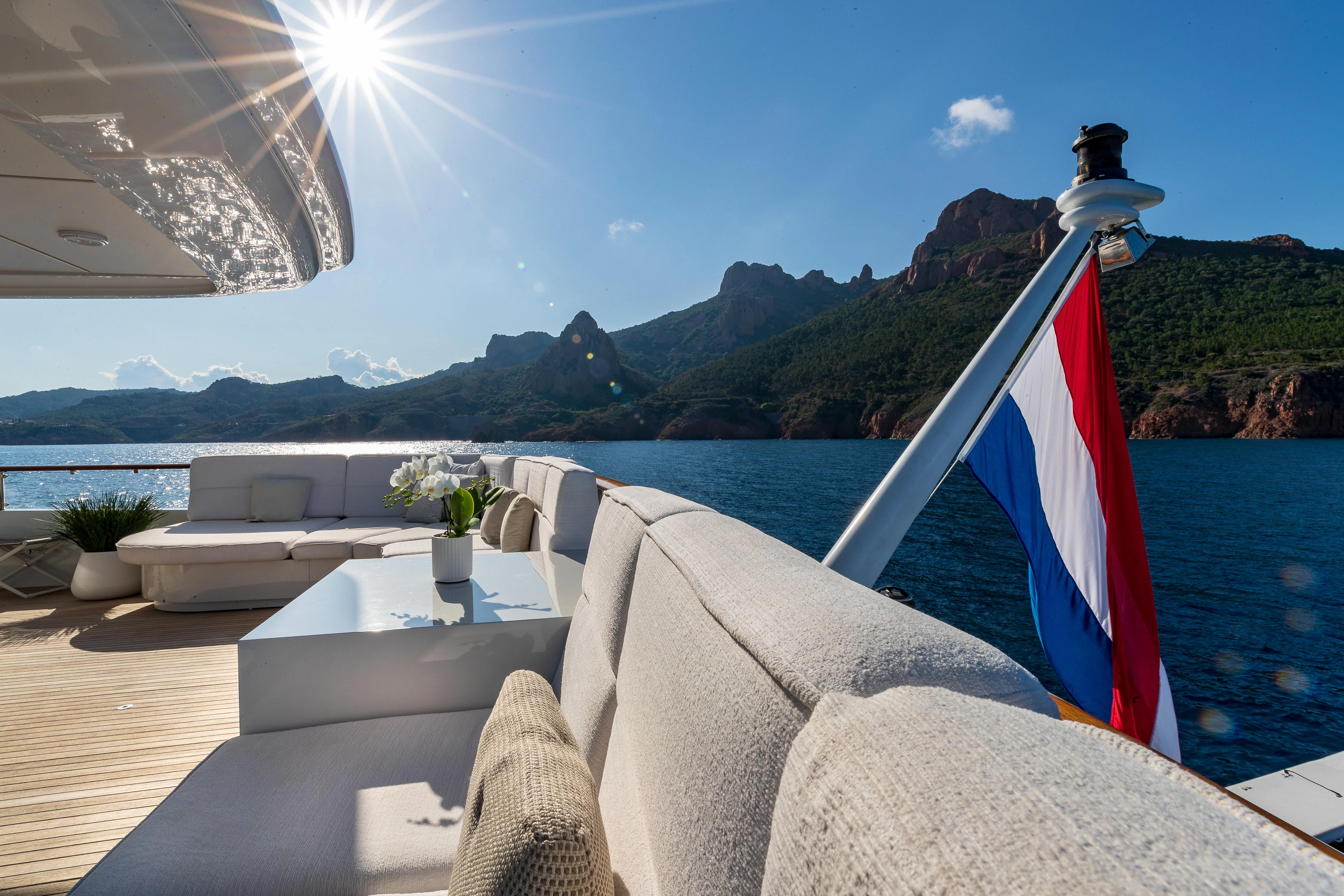 a boat with a flag on it aboard FRIENDSHIP Yacht for Charter