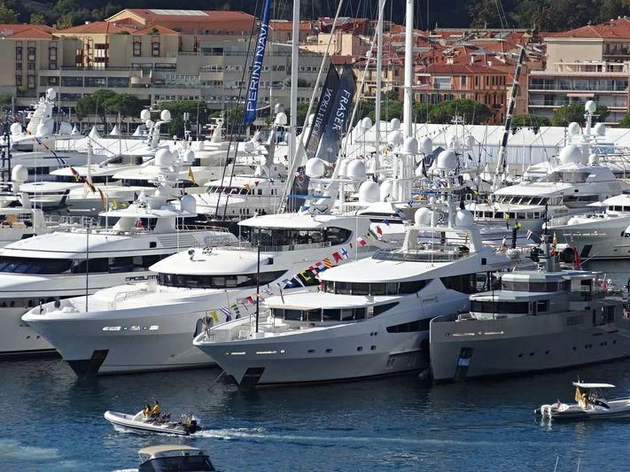 several white yachts in a harbor aboard FRIENDSHIP Yacht for Charter