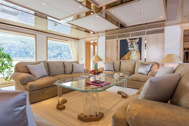 a living room with a table and couches aboard FRIENDSHIP Yacht for Charter