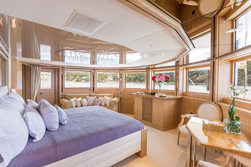 a bedroom with a bed and a table aboard FRIENDSHIP Yacht for Charter