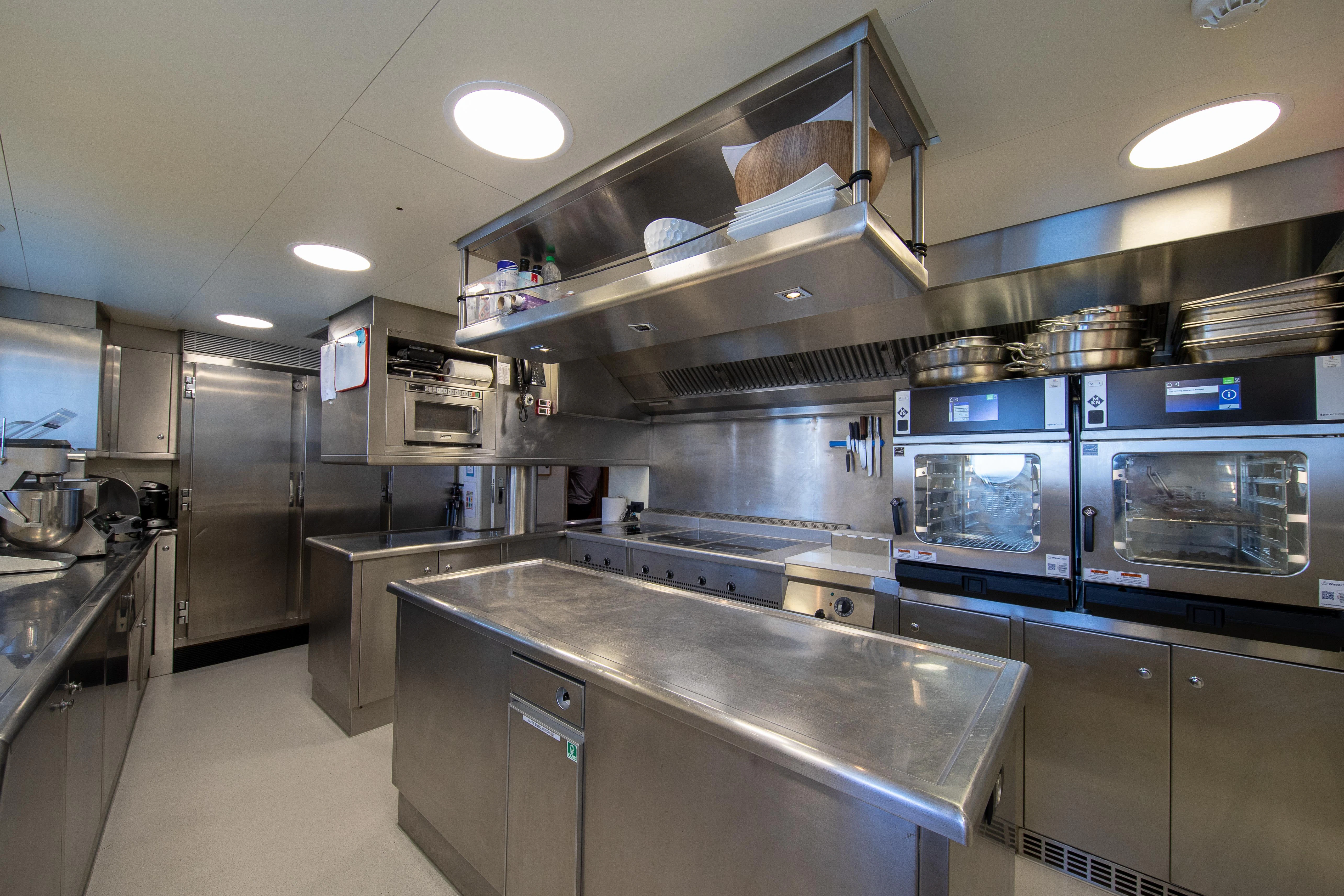 a kitchen with stainless steel appliances aboard FRIENDSHIP Yacht for Charter